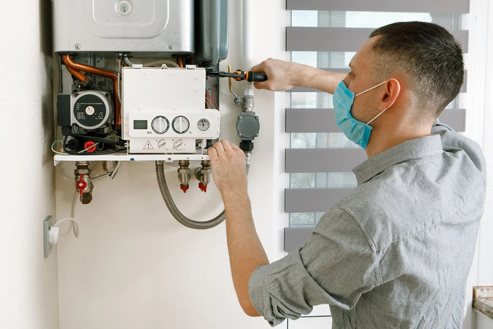 tech repairing a hot water heater Doctor Fix It Plumbing, Heating, Cooling and Electric’s Tips to Keep Your Hot Water Running | Doctor Fix It Plumbing, Heating, Cooling and Electric