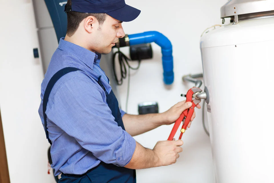 tech repairing a hot water heater Doctor Fix It Plumbing, Heating, Cooling and Electric’s Tips to Keep Your Hot Water Running | Doctor Fix It Plumbing, Heating, Cooling and Electric
