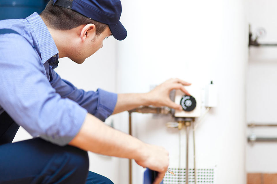 Plumber repairing hot water heater e